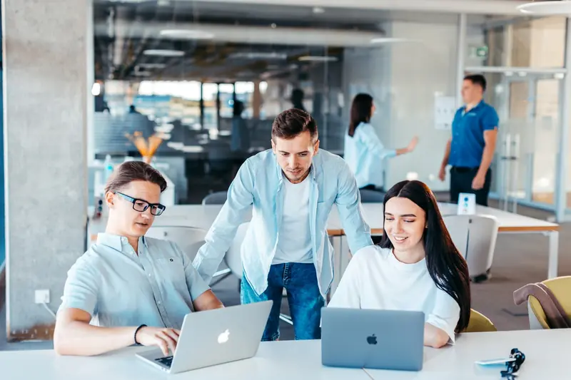Team arbeitet gemeinsam an Laptops